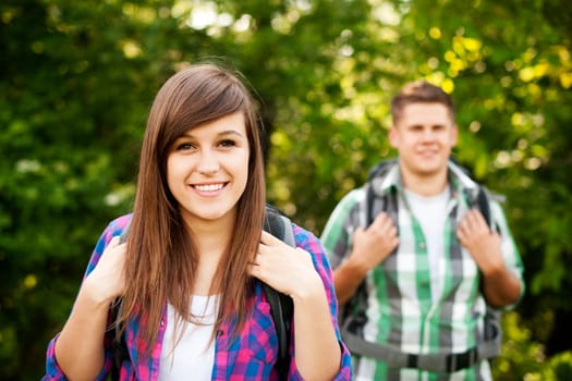 Young couple walking through forest
