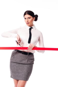Serious and focus businesswoman cutting a red ribbon