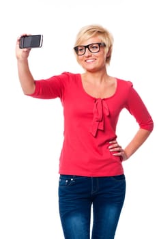 Blonde woman wearing glasses taking self portrait photo