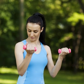 Young woman with dumbbells