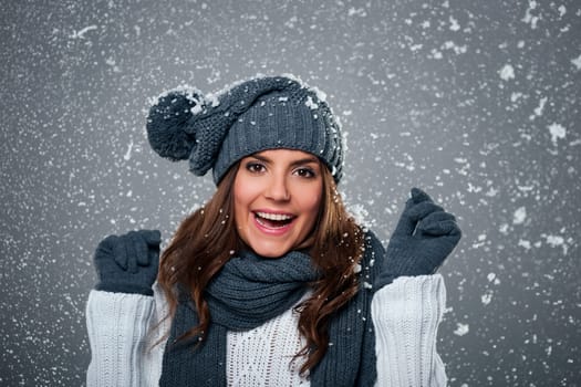 Young ecstatic woman enjoys first snow