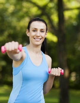 Young woman with dumbbells