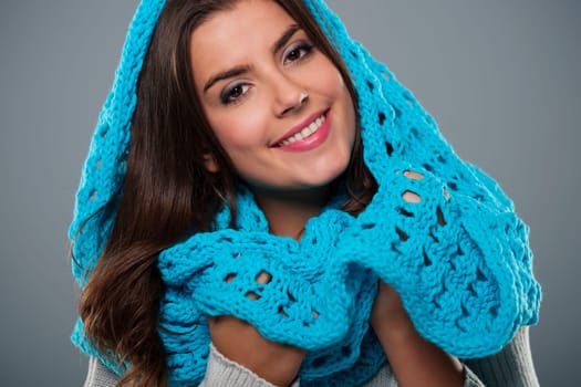 Portrait of beautiful woman wearing big blue scarf