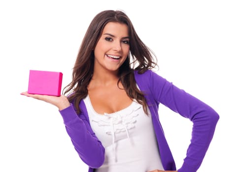 Cute young woman holding pink present