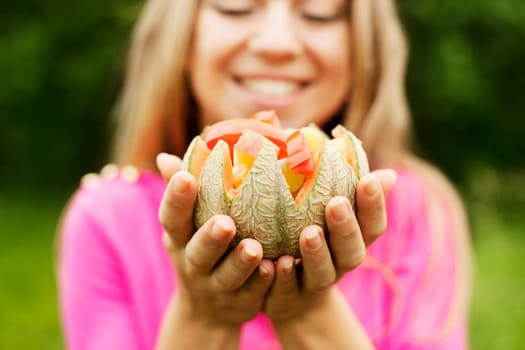 Young woman holding fruits and vegetables
