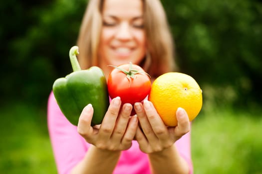 Young woman holding fruits and vegetables