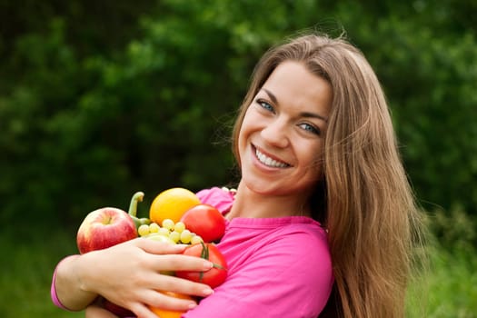 Young woman holding fruits and vegetables