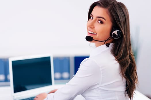 Young female operator with headphones