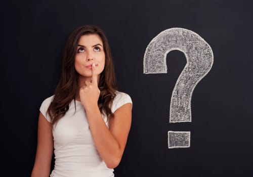 Woman with question mark on blackboard