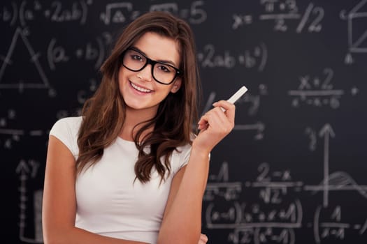 Portrait of beautiful female student with chalk
