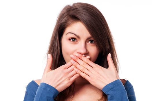 Beautiful young woman with hands covering mouth