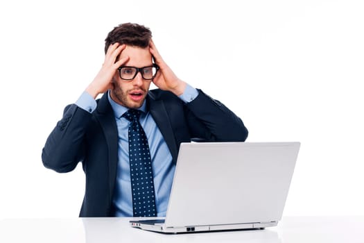 Shocked businessman looking at laptop