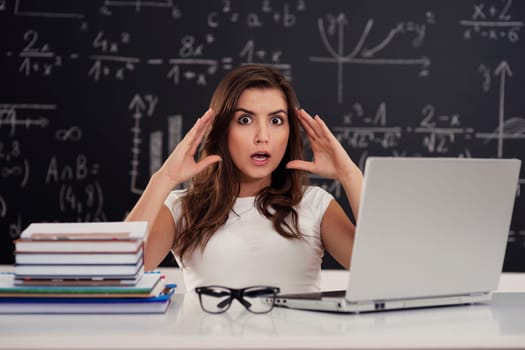 Terrified young woman in classroom