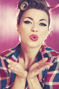Pin-up girl blowing a kiss