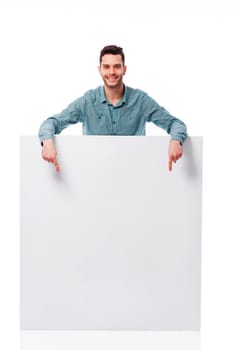 Happy young man pointing at empty board