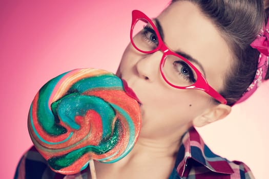 Pin up girl eating lollipop