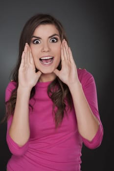 Woman screaming with hands next to her face