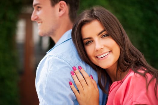 Portrait of beautiful woman embracing her boyfriend