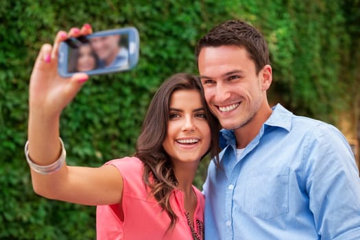 Happy couple making a photo of themselves