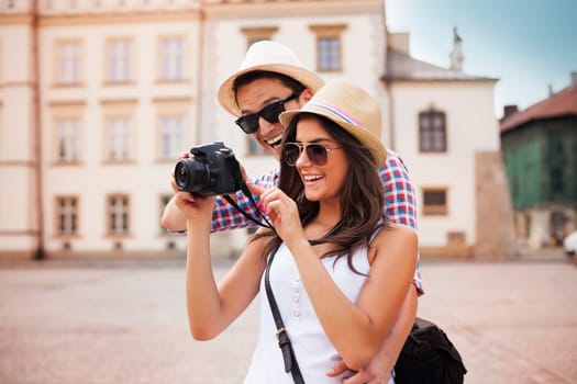 Cute couple looking on their photos on camera