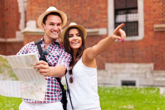 Woman pointing at something to her boyfriend during sightseeing