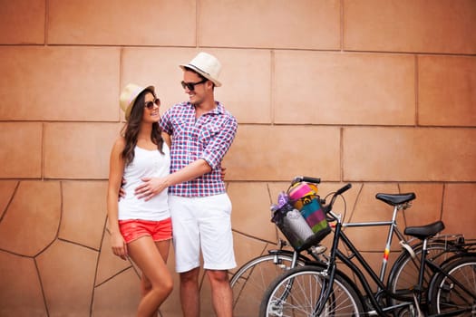 Young couple standing against the wall and hugging