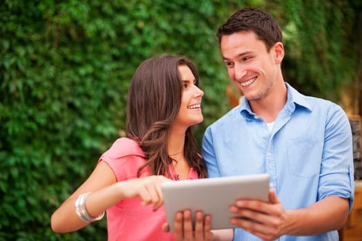 Young couple using digital tablet
