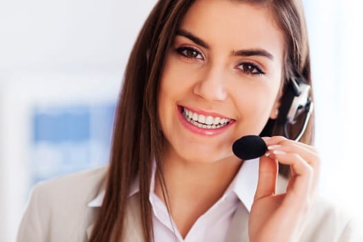 Happy female wearing headset and looking at camera