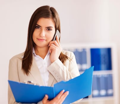 Busy businesswoman in talking on smart phone