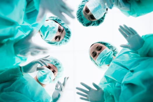 Surgeons standing above of the patient before surgery