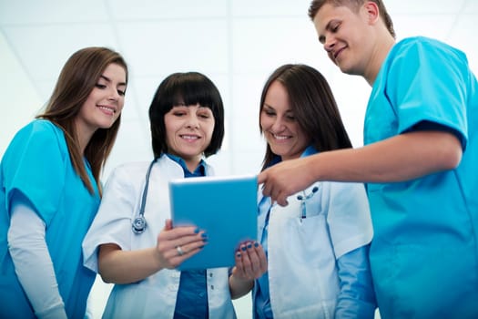 Medical team checking results on digital tablet