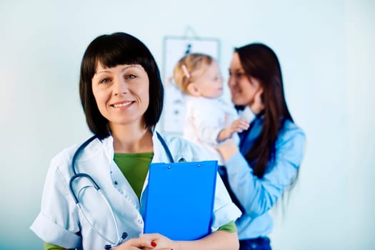 Smiling doctor holding notes