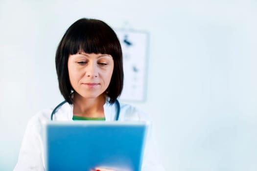 Female doctor holding tablet