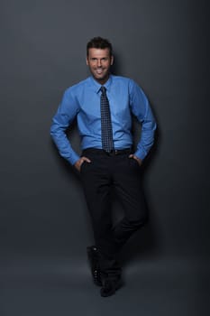 Relaxed and confident businessman looking at camera