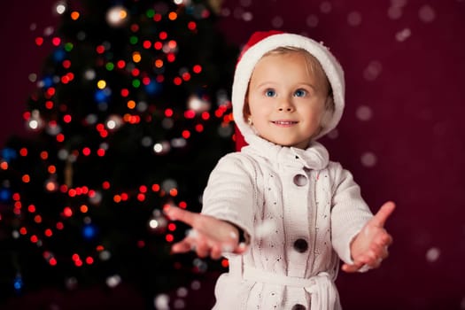 Santa little girl playing in snowflakes