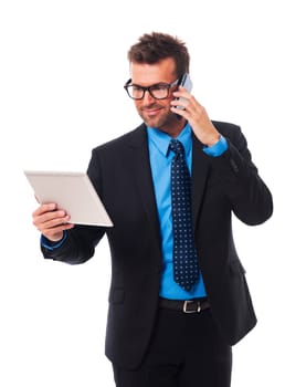 Busy businessman working on tablet and mobile phone