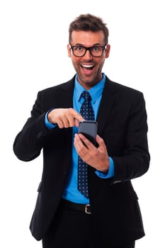Happy and surprised businessman pointing at mobile phone