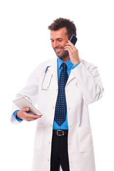 Doctor with mobile phone checking something on digital tablet