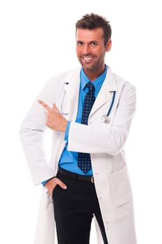 Happy doctor pointing at copy space