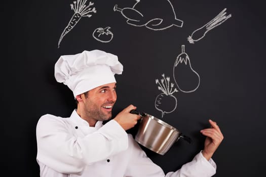 Handsome chef catching ingredients for soup