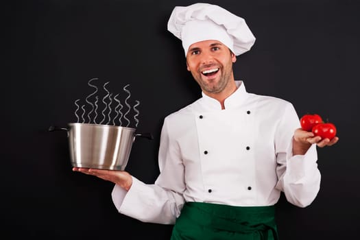 Happy chef recommending tomato soup