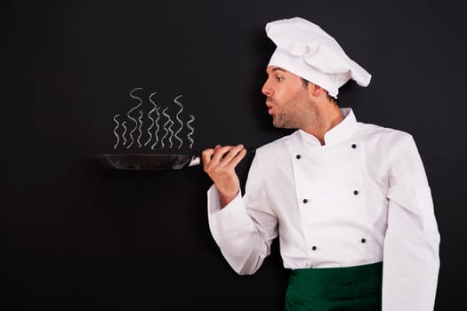 Chef blowing smoke from pan