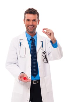Smiling doctor offering medicines