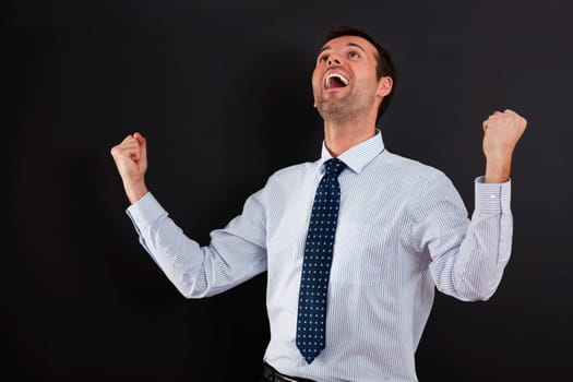 Handsome businessman cheering