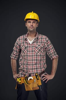 Portrait of handsome manual worker with tool belt