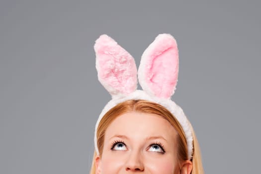 Easter bunny woman looking up