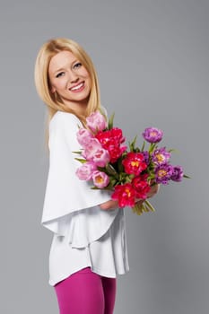 Smiling blonde woman with spring flower