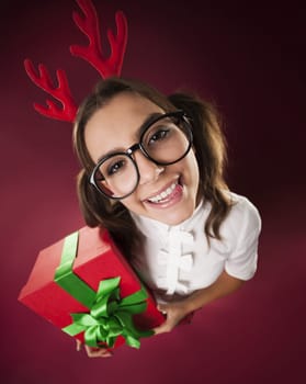 Nerdy woman with horns and christmas gift
