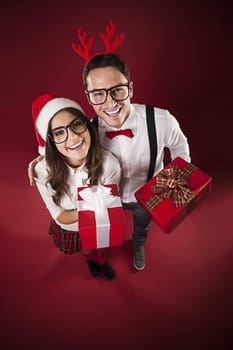 Portrait of funny couple with christmas present