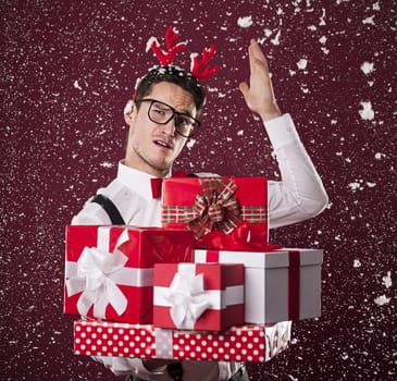 Grimacing man with stack of christmas presents